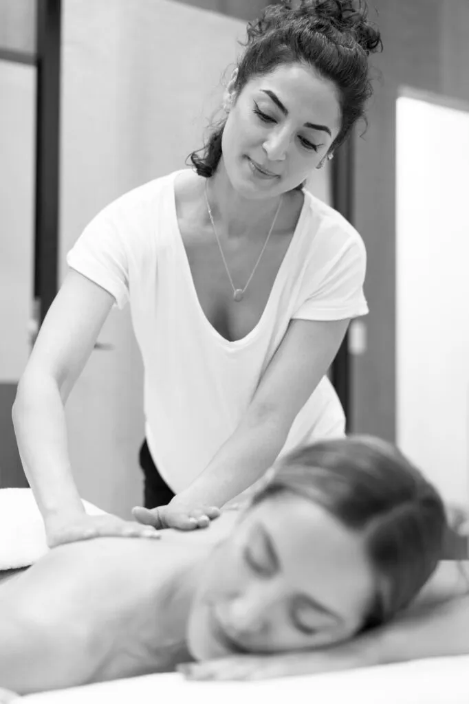 Woman receiving a relaxing back massage at a spa.