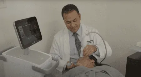Doctor performing non-surgical facial procedure on patient at plastic surgery center.