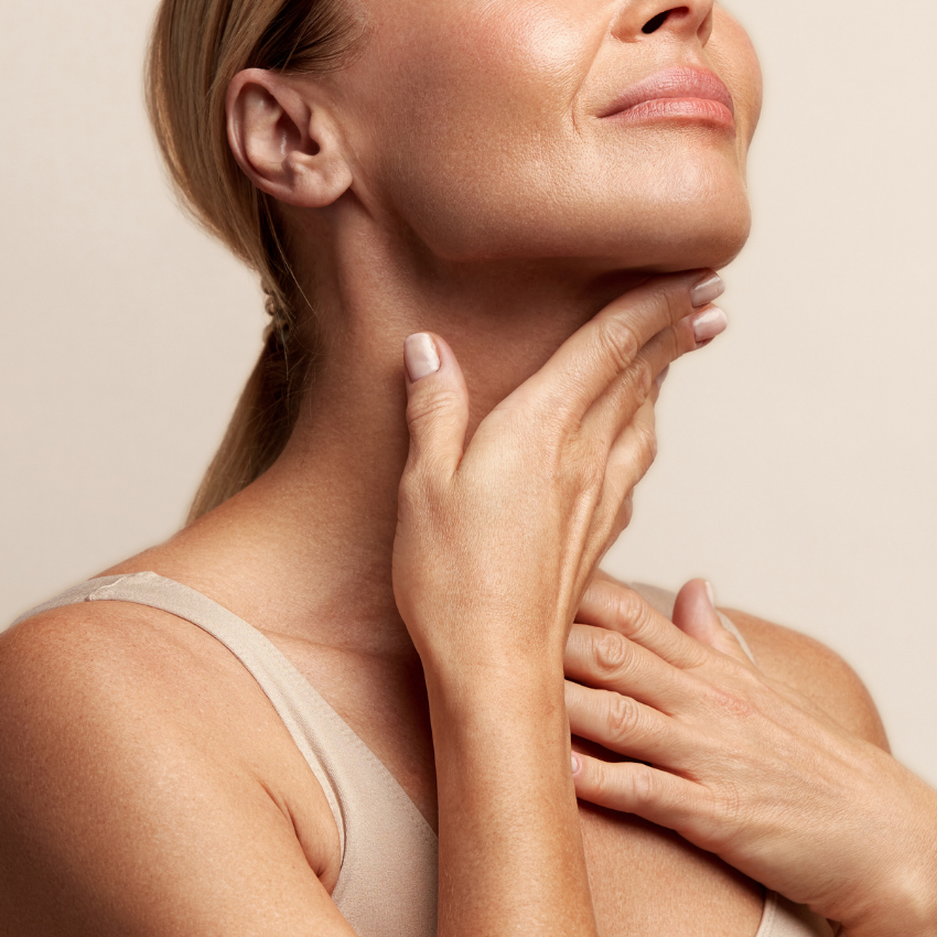 Woman receiving facial laser treatment at a plastic surgery center.