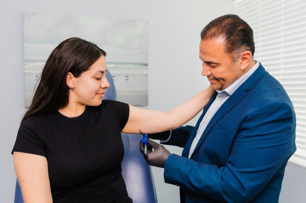 Plastic surgeon consulting with a patient in an office setting.