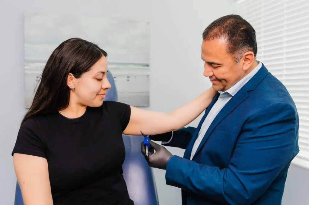 Plastic surgeon consulting with a patient in an office setting.