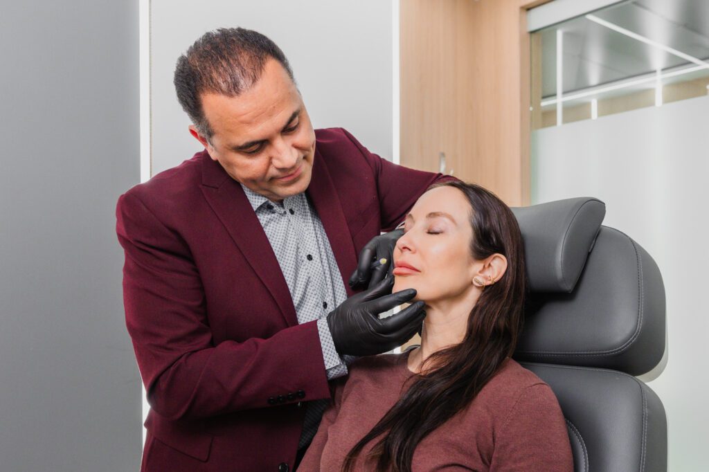 Plastic surgeon consulting with a patient in a modern office.