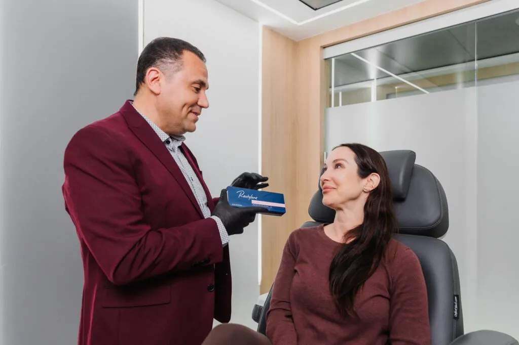 Plastic surgeon discussing treatment options with a patient in a modern consultation room.