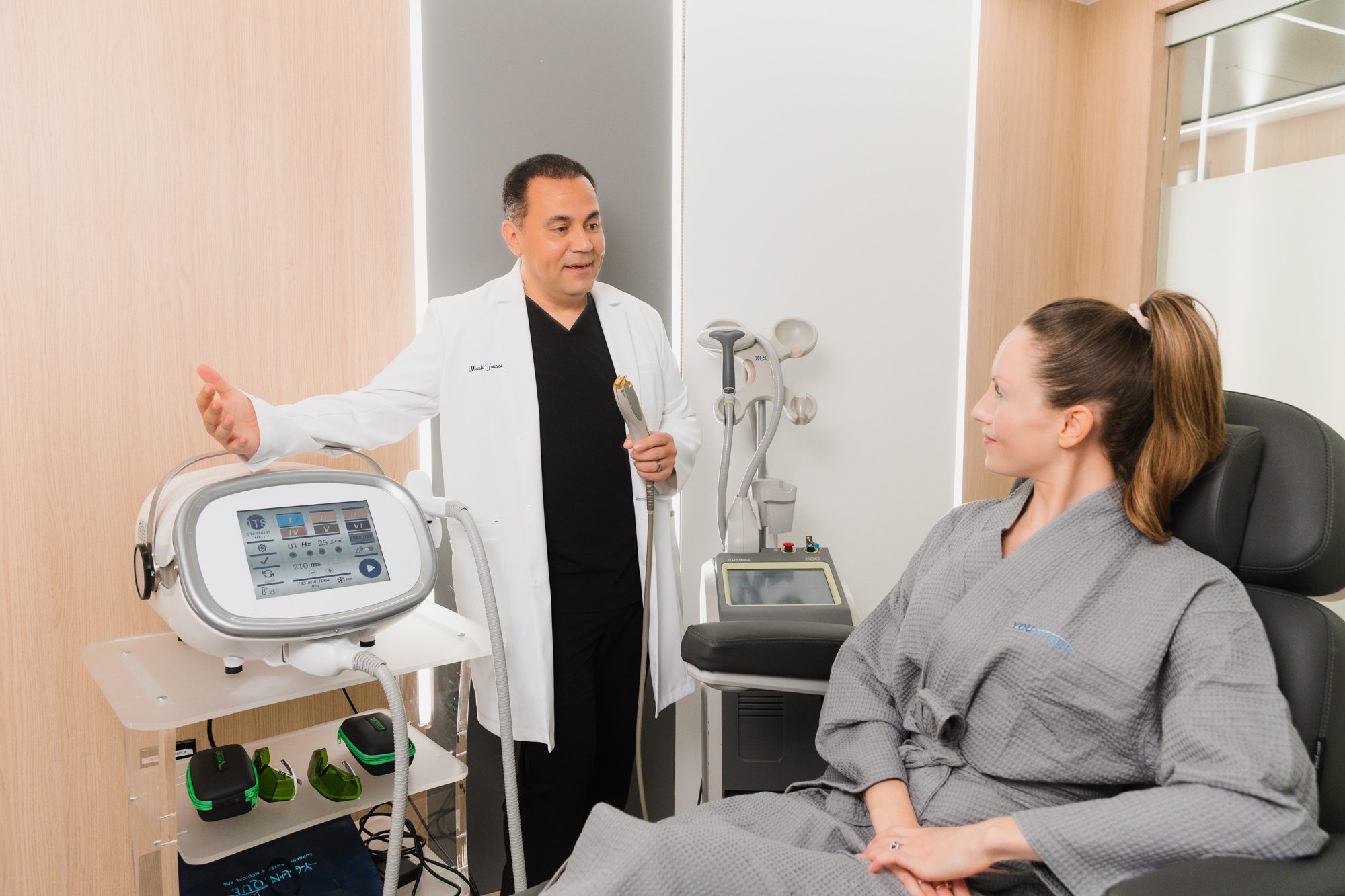 Plastic surgeon consulting with a patient in a modern clinic setting.