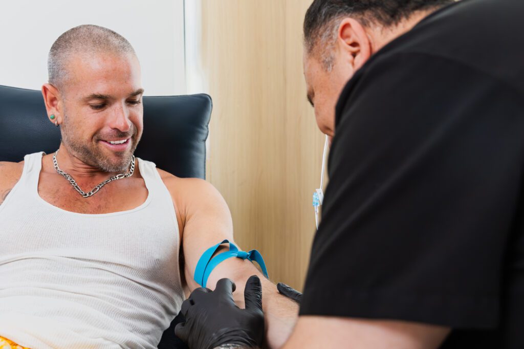 Man receiving an IV drip treatment at a plastic surgery center.