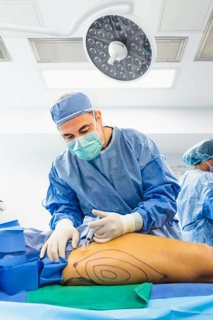 Surgeon performing a procedure in a modern operating room.