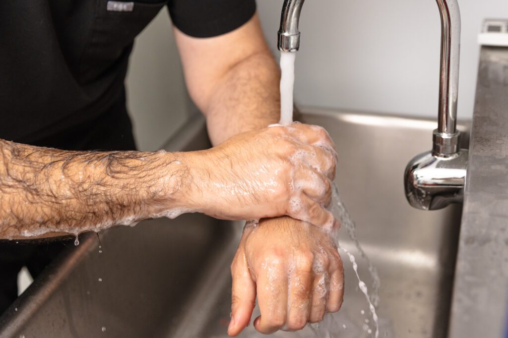 Surgeon washing hands at a plastic surgery center.