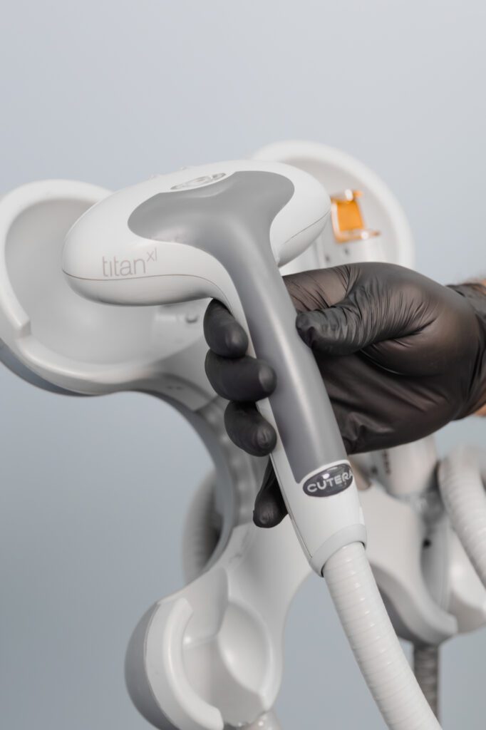 Medical professional holding laser surgery equipment in a plastic surgery center.